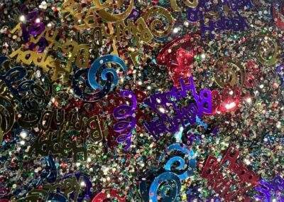Glitter and happy birthday confetti.