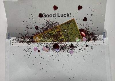 Show someone some love by adding glitter and heart confetti to your fake lottery scratcher mail prank.